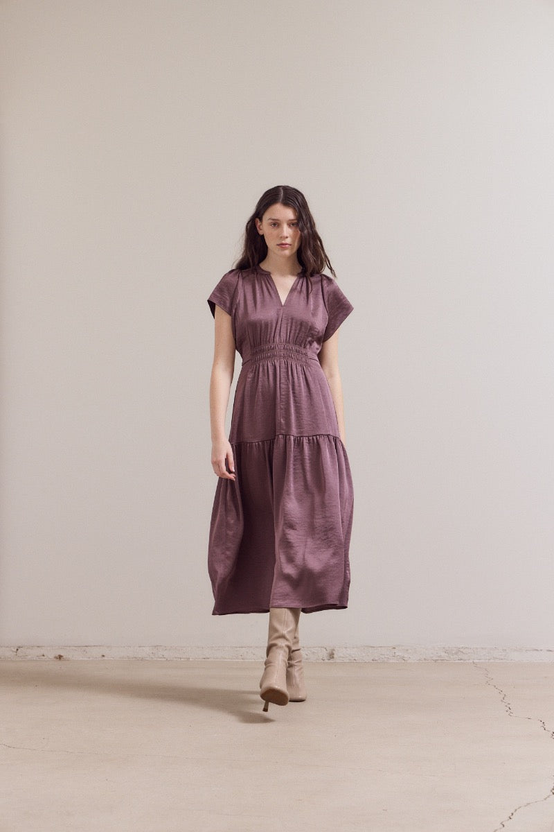 Dusty mauve linen midi dress with smocked waist, short sleeves, V-neckline and tiered ruffle hem paired with tan boots