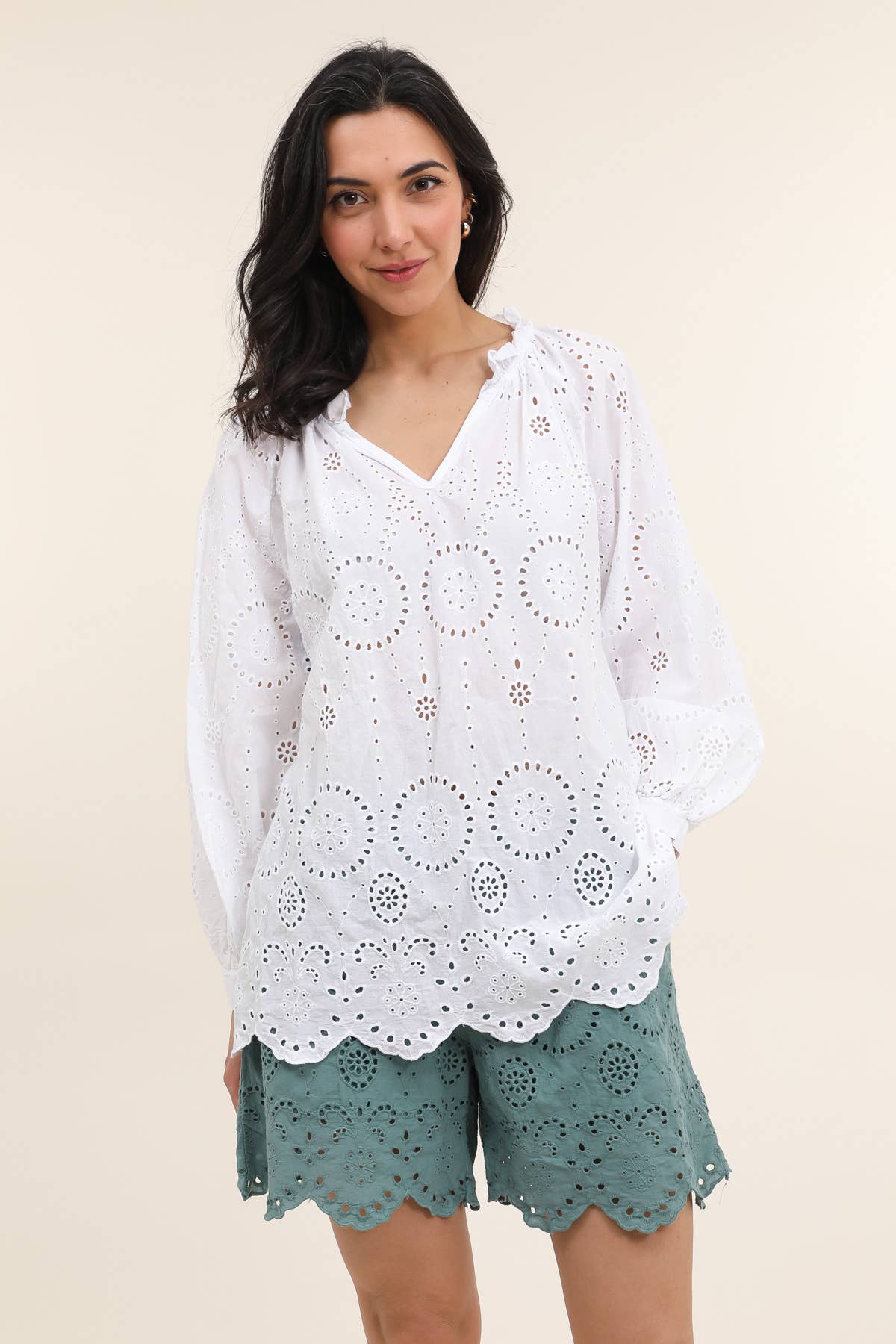 White cotton blouse with eyelet broderie anglaise cutwork in circular patterns, V-neck, scalloped hem, long sleeves