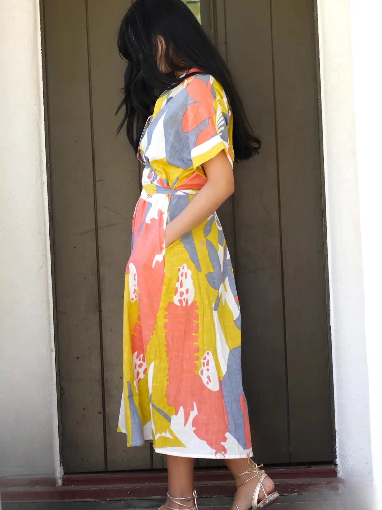Midi wrap dress with abstract painterly print in coral, mustard yellow, slate blue and white with tie waist and short sleeves