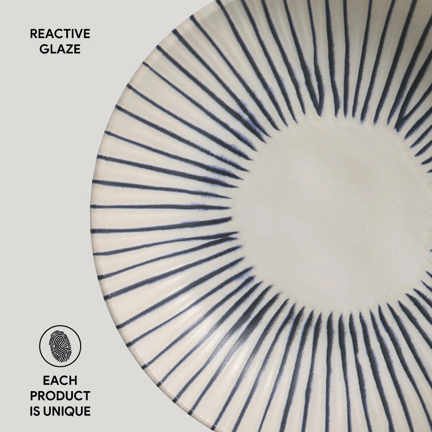 Ceramic plate with navy blue radiating lines from center in sunburst pattern on cream white reactive glaze surface