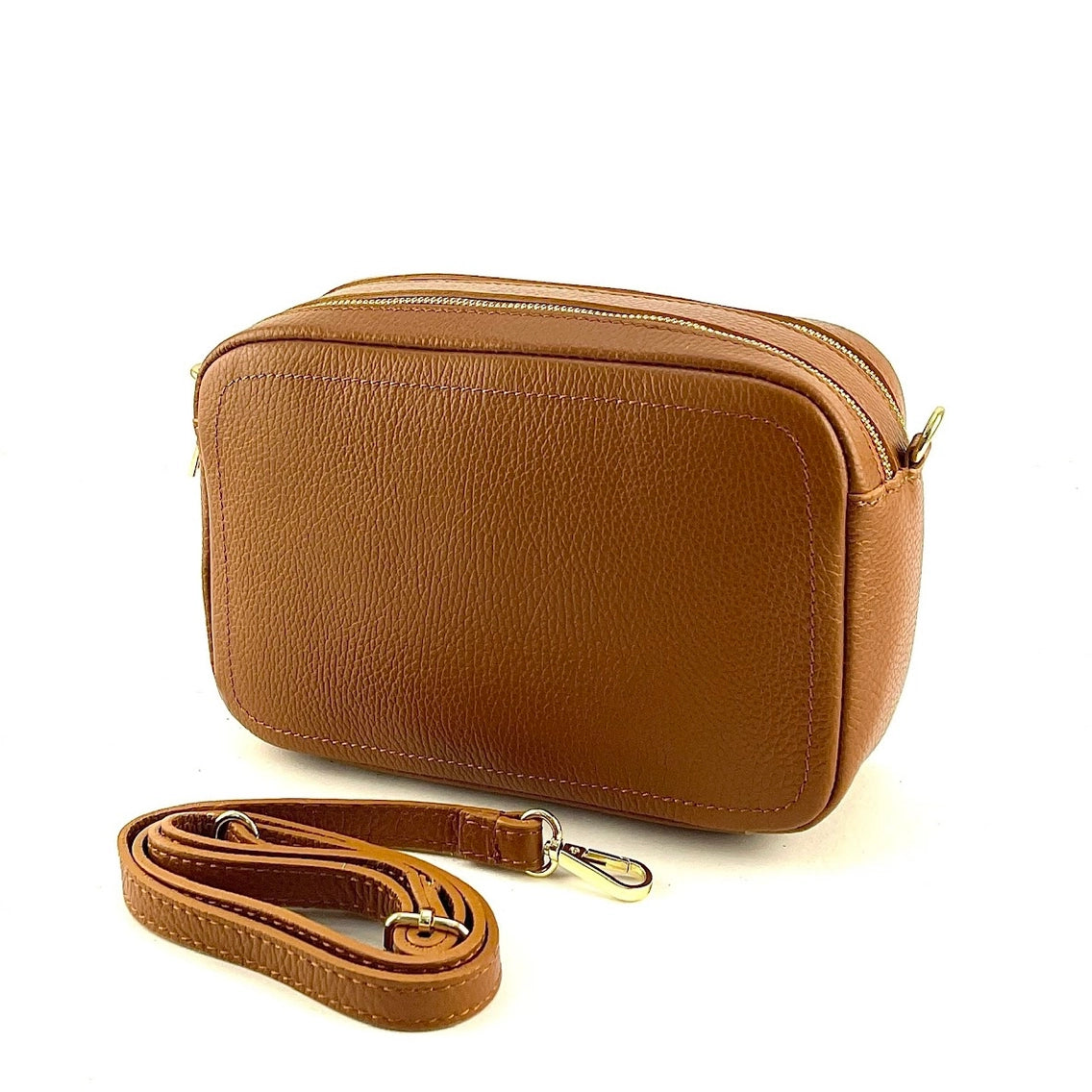 Tan pebbled leather crossbody bag with double gold zippers and detachable adjustable strap with silver clasp