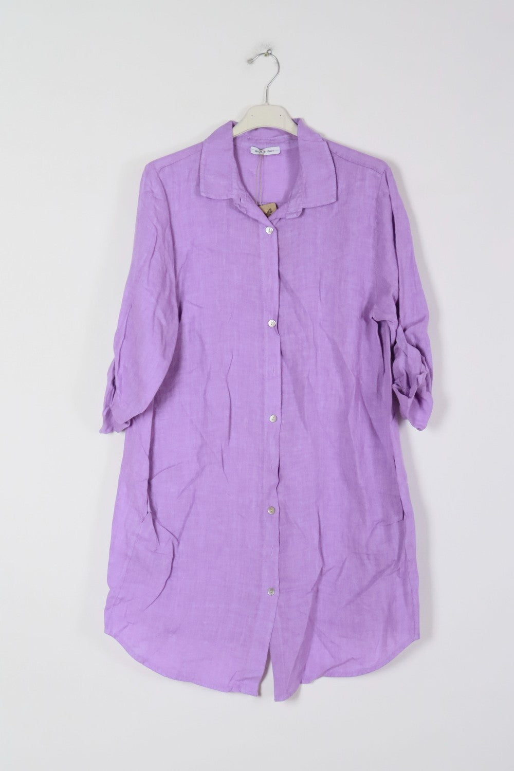 Lavender linen shirt dress with white button front, collar, rolled three-quarter sleeves, and relaxed tunic silhouette