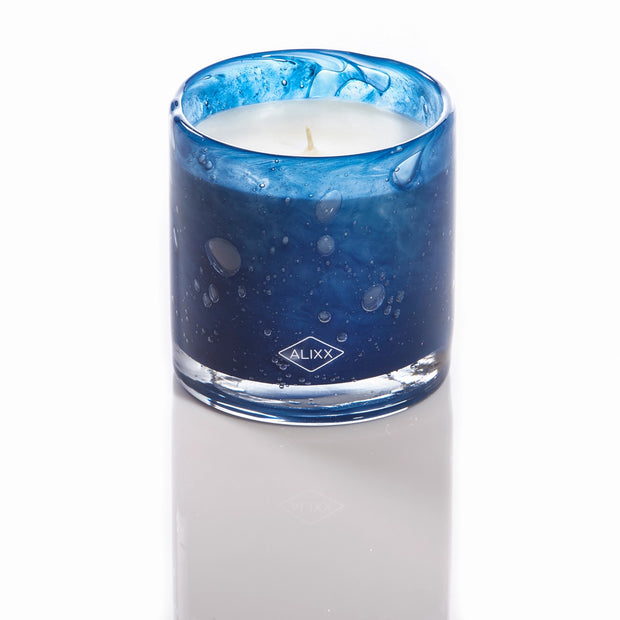 Blue gradient glass candle with water droplet effect, white wax, single wick, and Alixx diamond logo on front