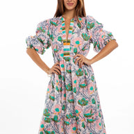 Cotton maxi dress with pink floral pattern, turquoise accents, puffed sleeves, striped trim, and V-neckline on white background