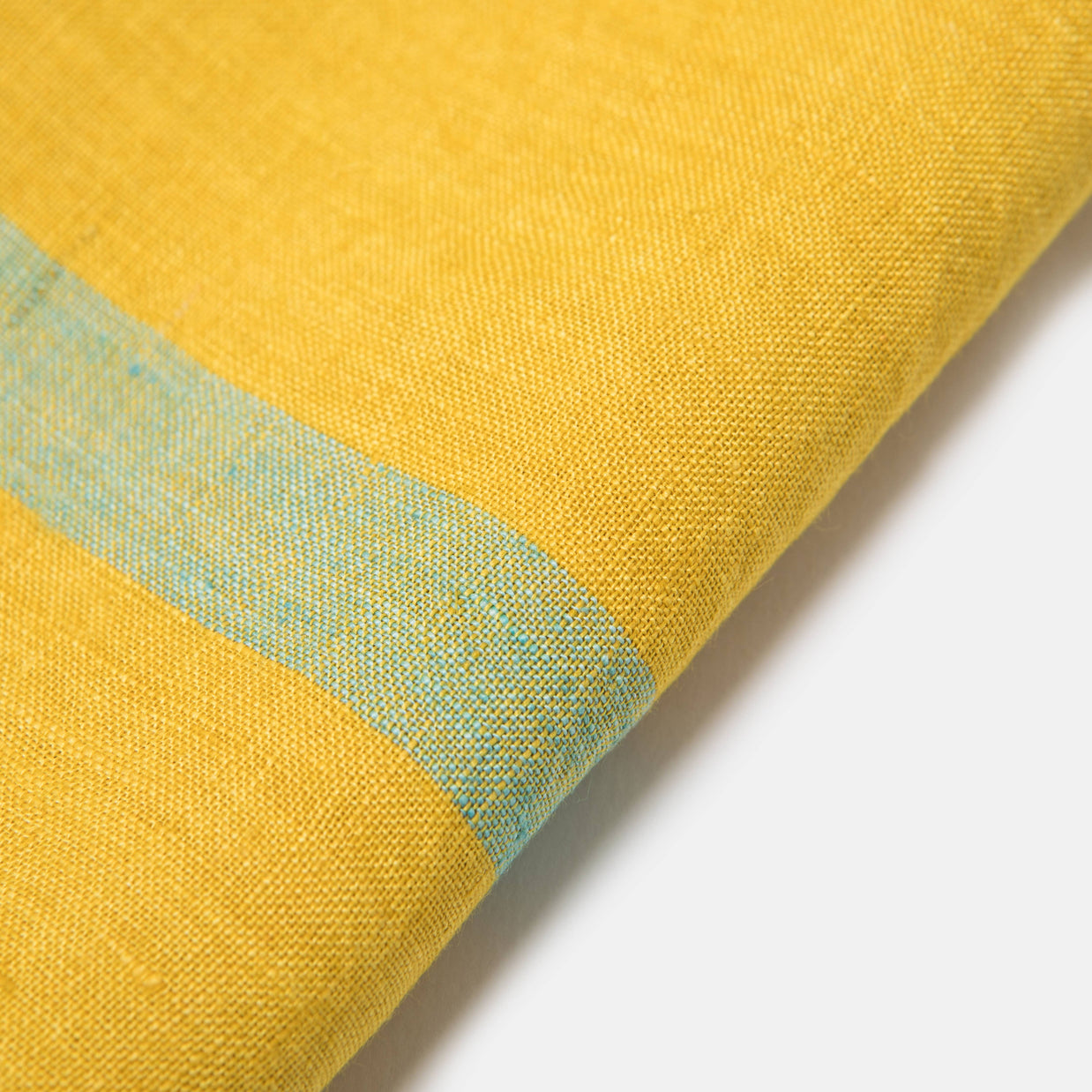 Golden yellow woven textile with light blue horizontal stripe pattern showing detailed weave texture and natural fabric drape