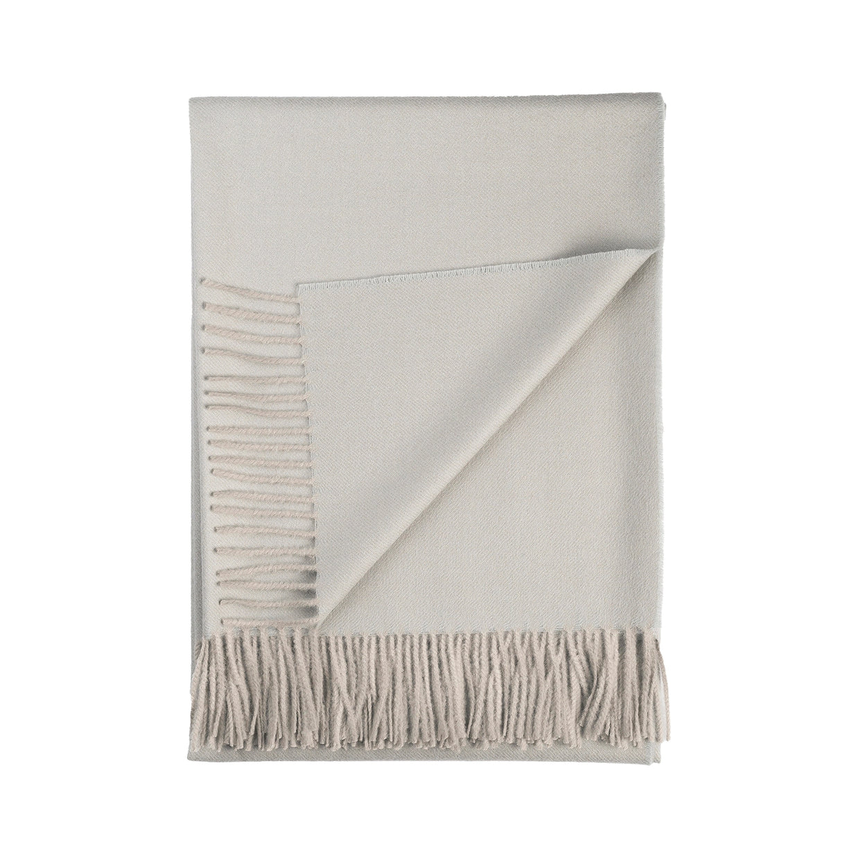Soft ivory wool throw blanket with diagonal twill weave texture and knotted fringe tassels along bottom edge