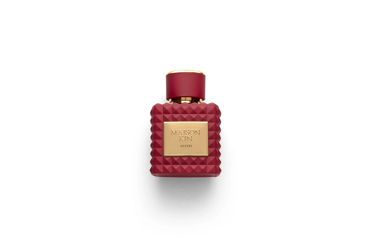 Maison Kin Alessi burgundy perfume bottle with geometric studded pattern and gold square label with matching cap