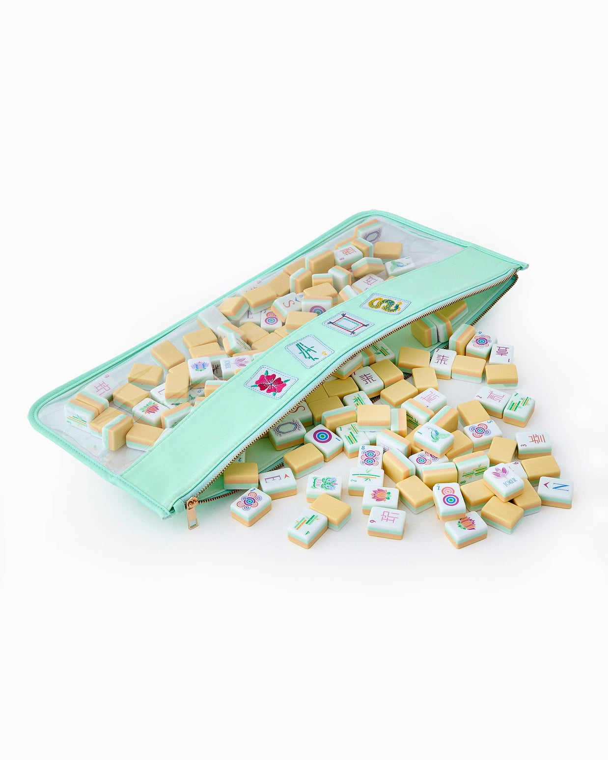 Mint green zippered case with clear window containing ivory mahjong tiles with colorful character and symbol engravings