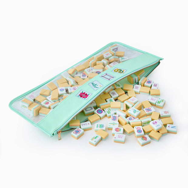Mint green zippered case with clear window containing ivory mahjong tiles with colorful character and symbol engravings