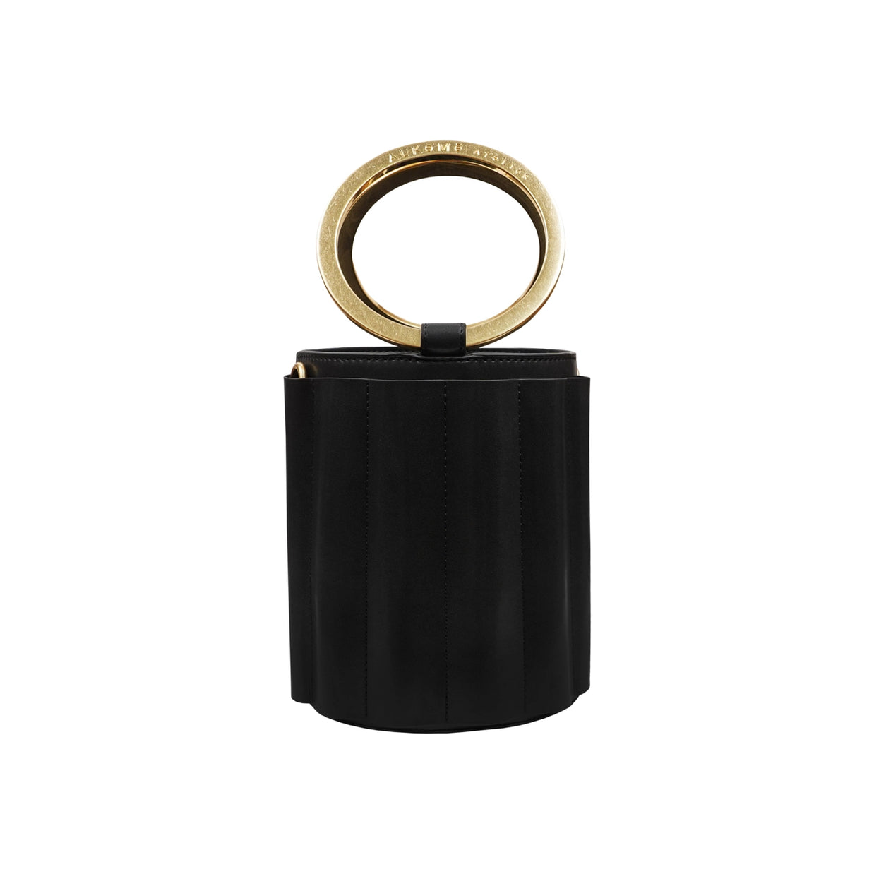 Black suede cylindrical bucket bag with brass circular ring handle and vertical topstitching details