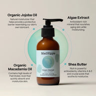 Amber glass pump bottle of MadHippie cream cleanser with black dispenser and minimalist sage green label on beige background