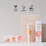 MadHippie Blemish Cream tube and box with watercolor peach and pink circles, displayed against textured stone backdrop