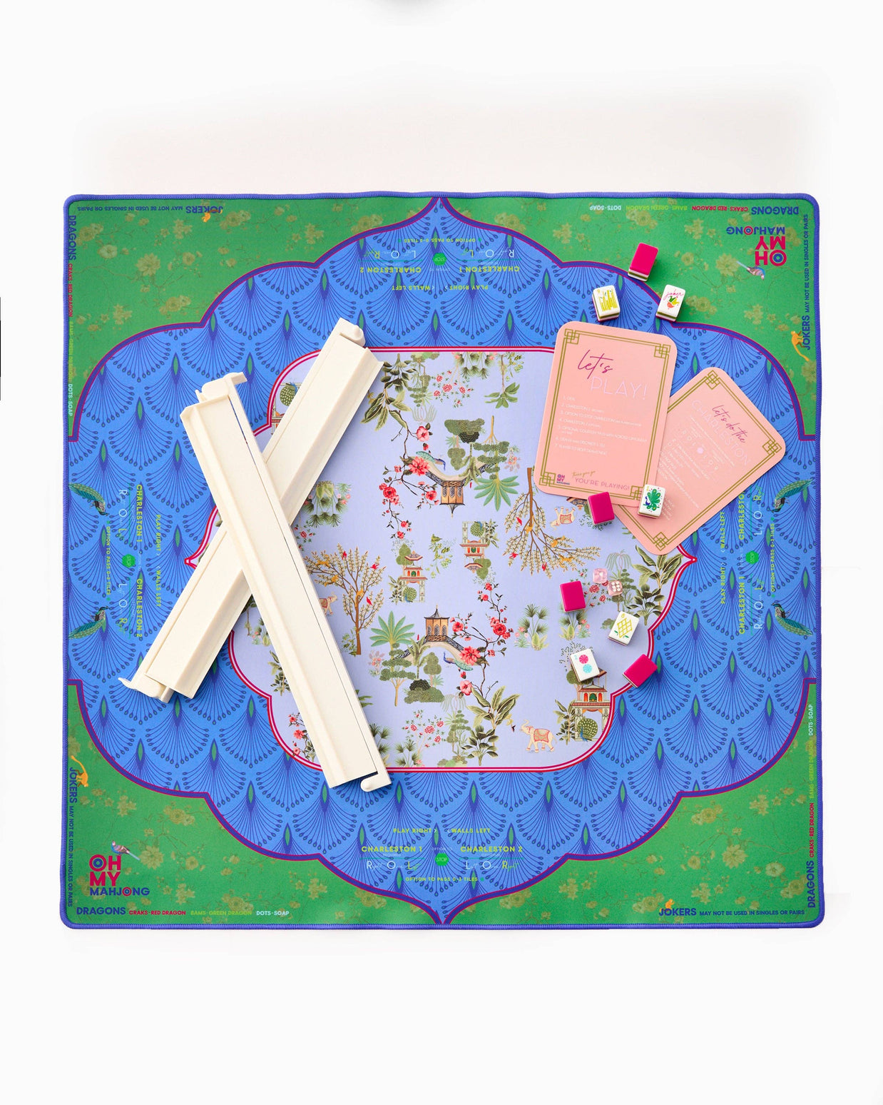 Mahjong game set with ornate playing mat featuring blue scalloped borders, chinoiserie pagoda center, ivory tiles and pink cards