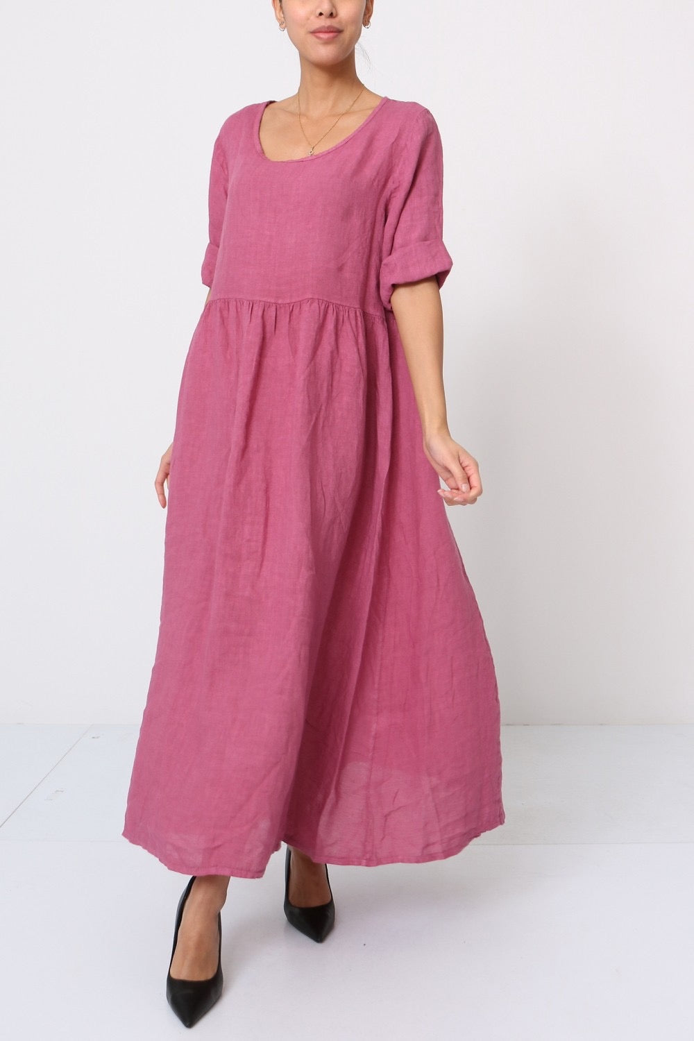 Mauve pink linen maxi dress with gathered waist, rolled short sleeves, and scoop neckline in relaxed flowy silhouette