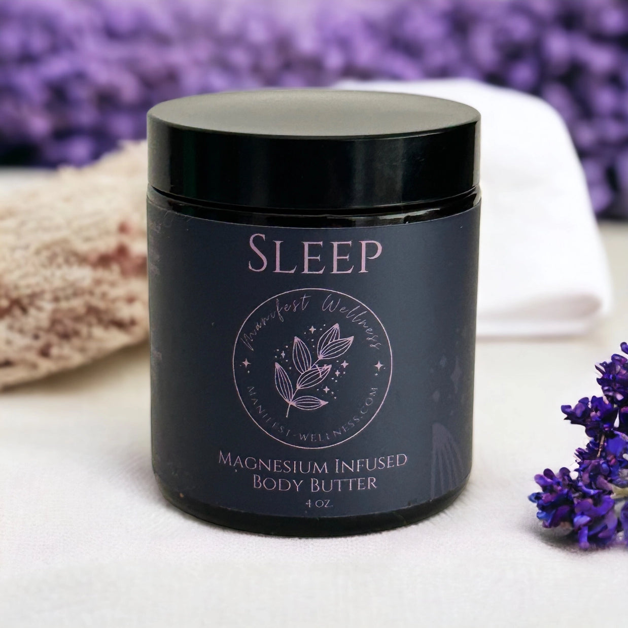 Black glass jar with black lid containing magnesium-infused body butter, featuring purple Sleep text and botanical leaf design
