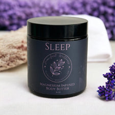 Black glass jar with black lid containing magnesium-infused body butter, featuring purple Sleep text and botanical leaf design