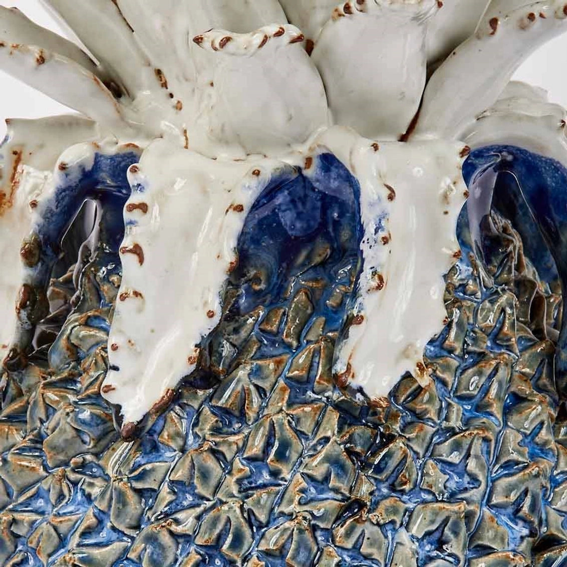 Ceramic vessel with cobalt blue interior dripping into textured metallic bronze base and white crackled glazed exterior rim