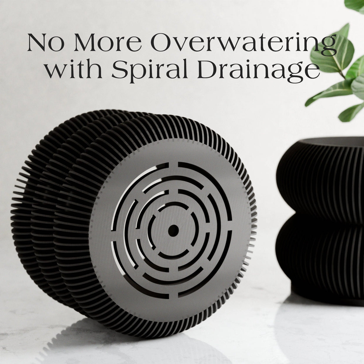 Black ridged planter with spiral drainage pattern on bottom, modern cylindrical design with vertical ribbed texture