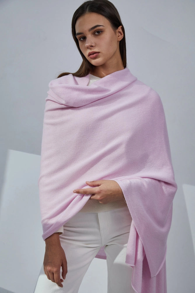 Soft lilac cashmere wrap shawl draped over shoulders styled with white button-up shirt and ivory trousers