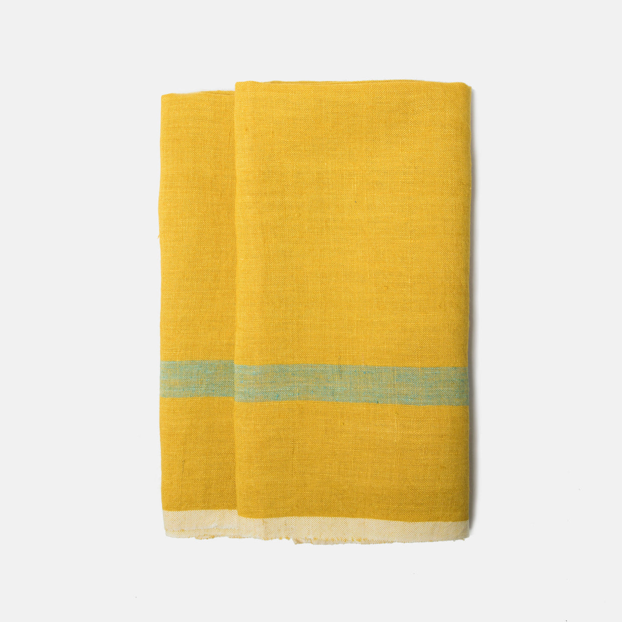 Golden yellow linen tea towel with sage green horizontal stripe and cream fringe hem folded on white background