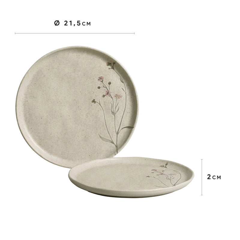 Speckled cream stoneware plate with hand-painted delicate pink wildflower stems along right edge, shallow rim design