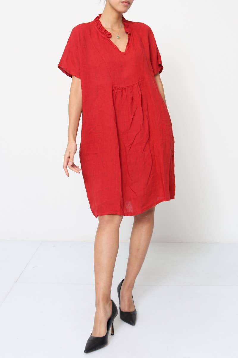 Red linen knee-length dress with ruffled V-neckline, short rolled sleeves, relaxed A-line silhouette, and gathered waist detail.