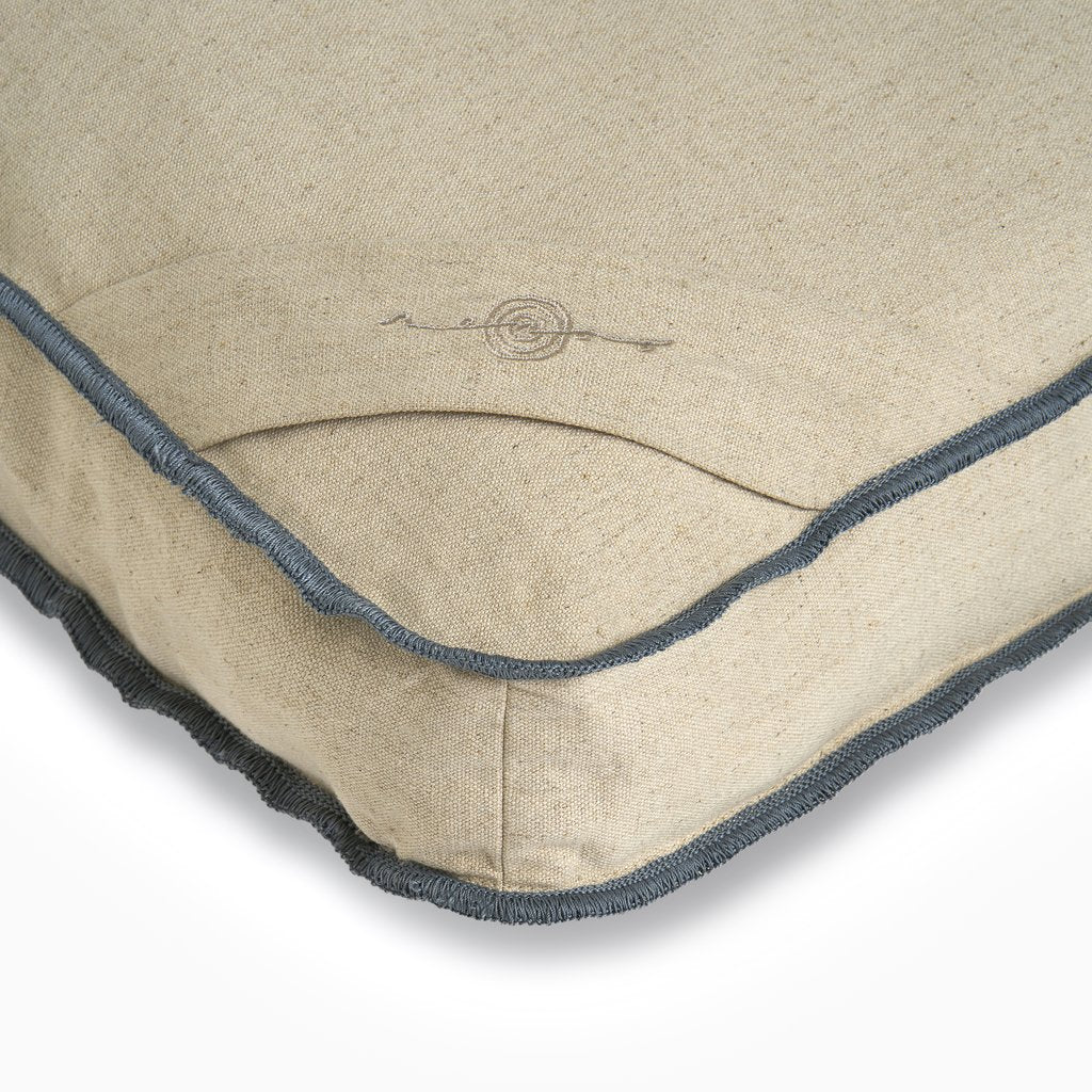 Natural linen cushion cover with charcoal gray whipstitch border and decorative rope knot embroidery detail at center
