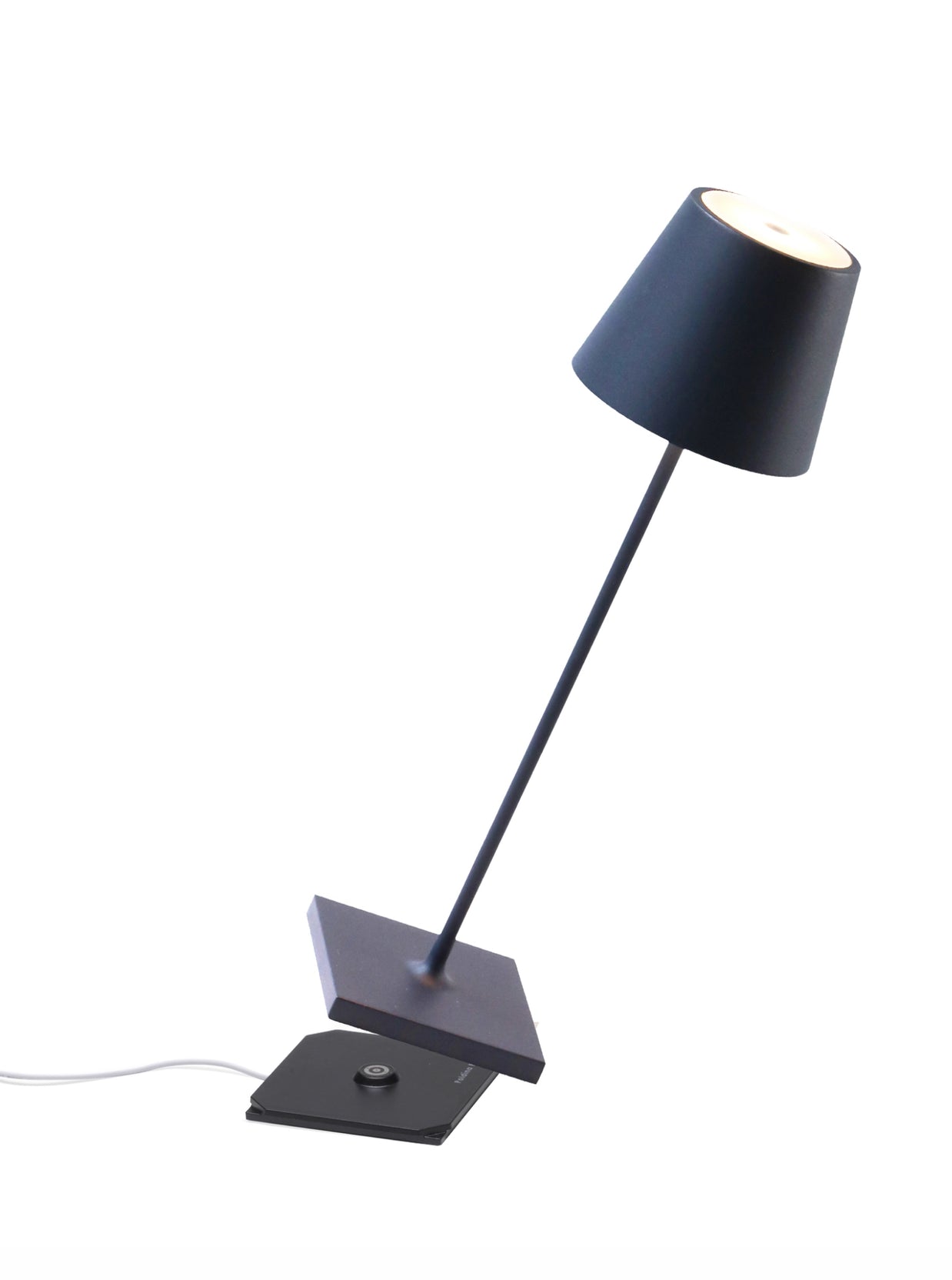 Modern navy blue desk lamp with tapered fabric shade, angled metal stem, and rectangular base with wireless charging pad