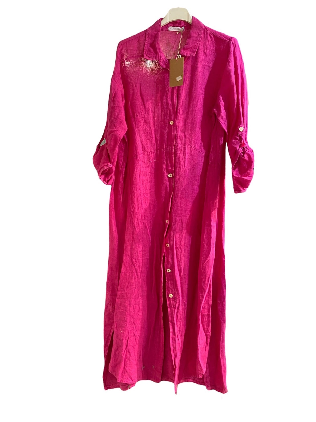 Bright fuchsia pink linen shirt dress with collar, white button front, rolled tab sleeves, and embroidered yoke detail