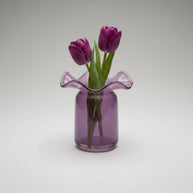 Lavender purple glass vase with ruffled wavy rim on cylindrical base with glossy translucent finish