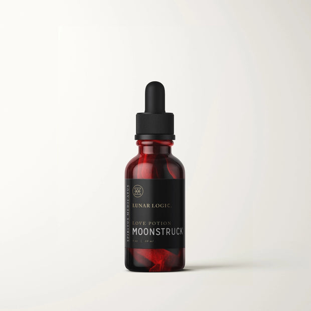 Deep red glass dropper bottle with black cap and label reading Lunar Logic Moonstruck Love Potion with rose petal inside