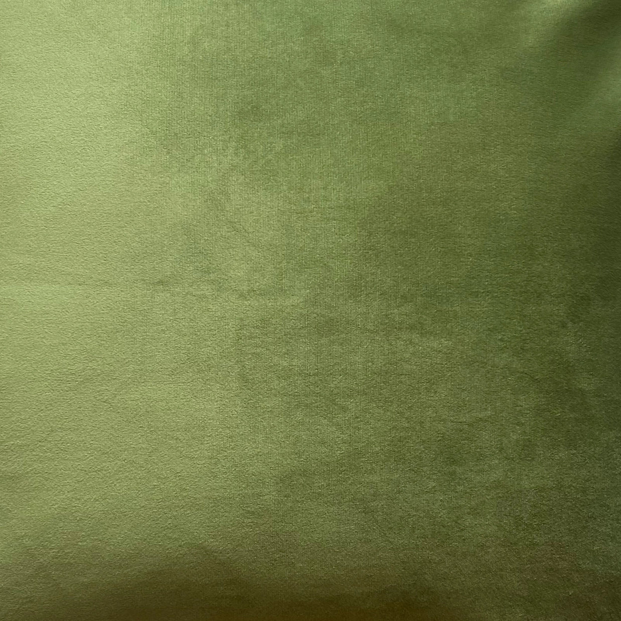 Soft sage green cotton jersey knit fabric with subtle draping and natural texture showing light and shadow variations