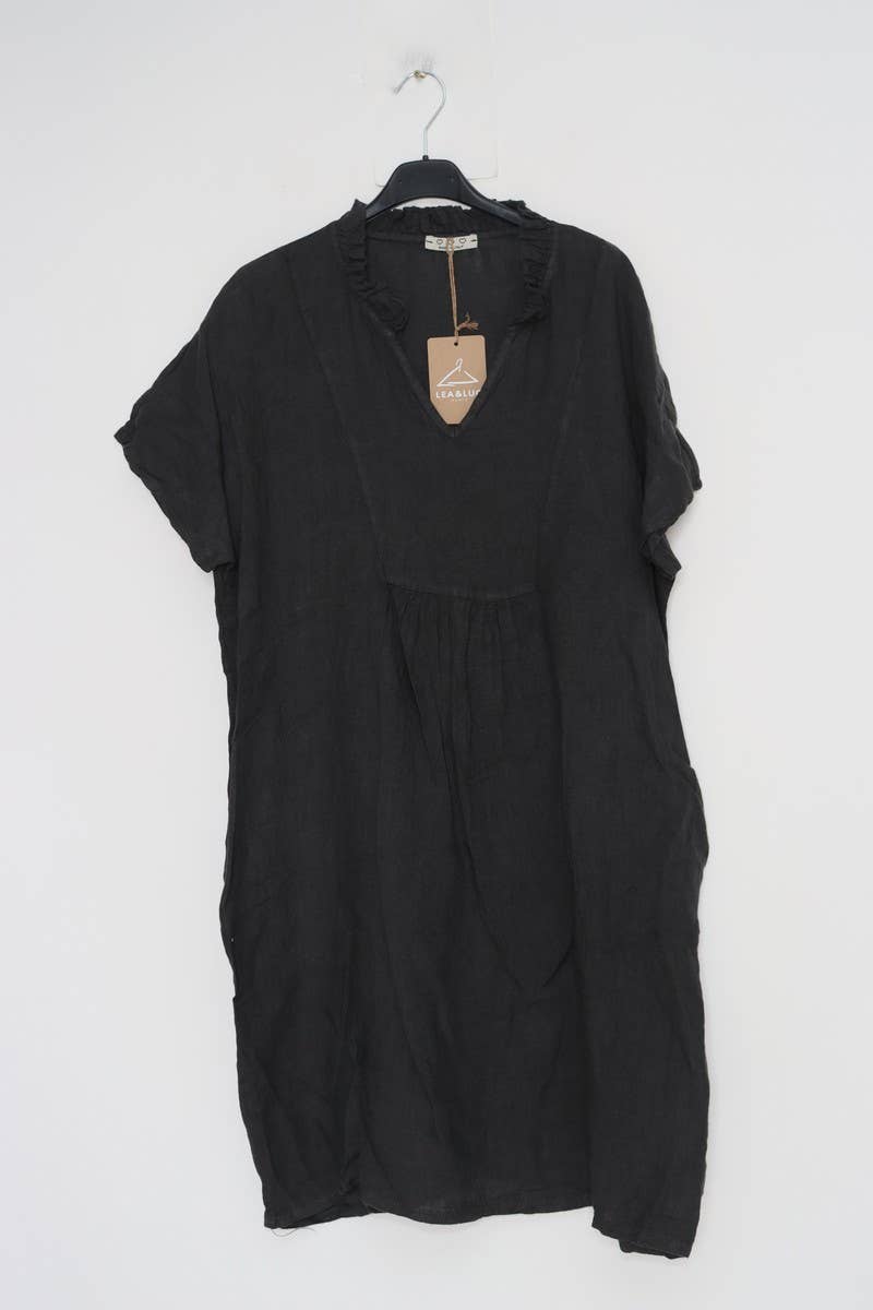 Black linen short-sleeve shift dress with ruffled v-neck collar and gathered waist on hanger with tan brand tag