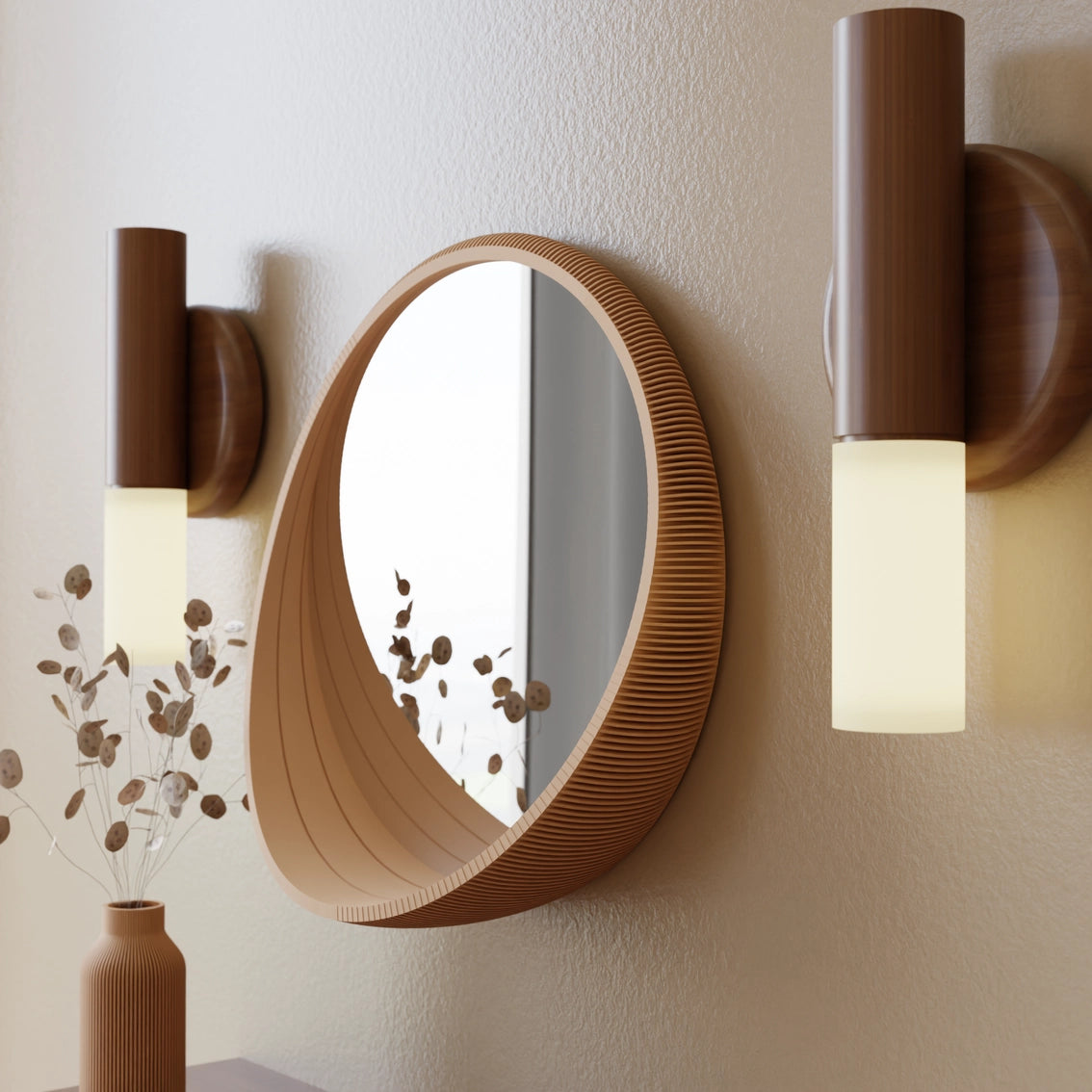 Round wall mirror with layered wood frame in warm brown tones with ribbed texture flanked by modern walnut sconces with cream shades