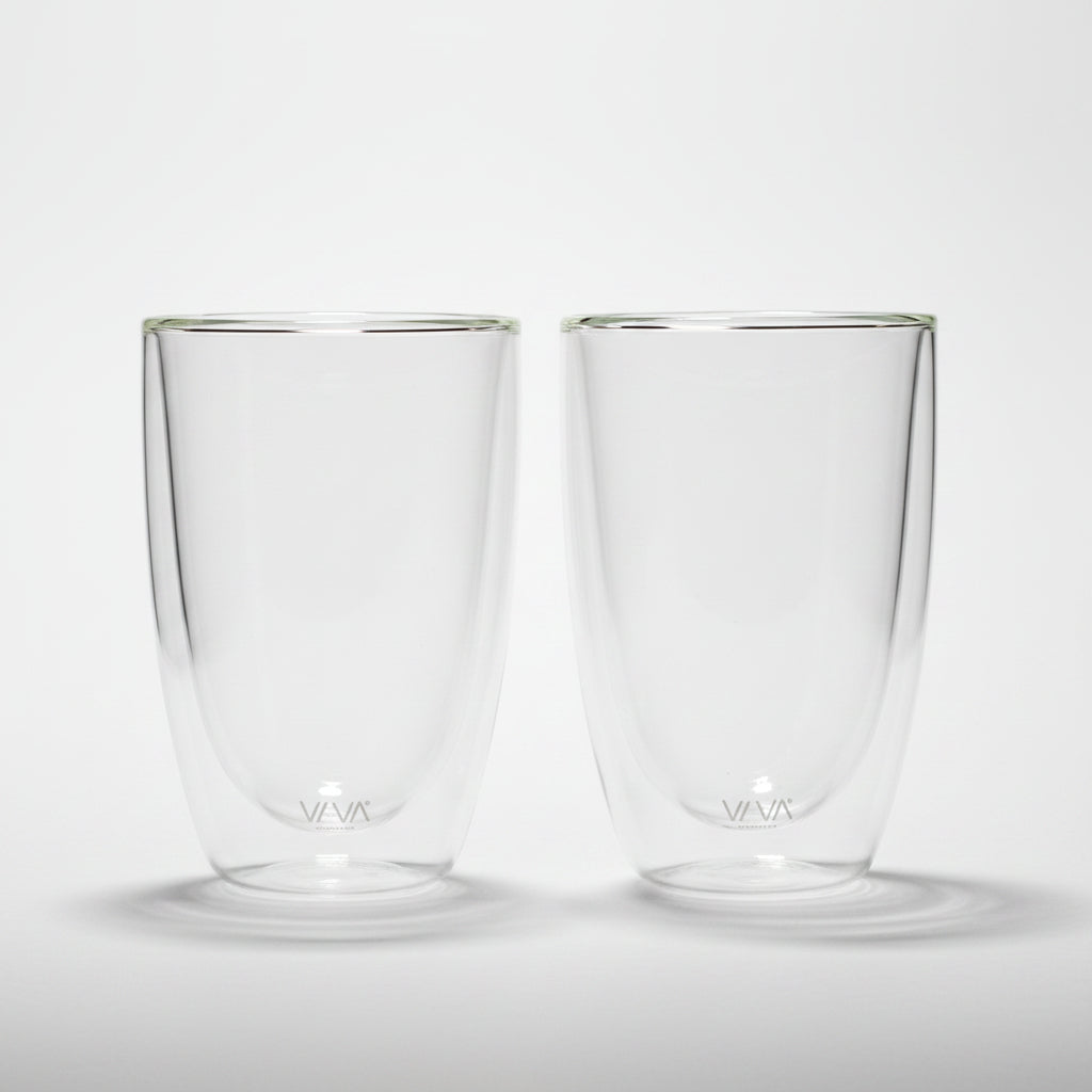 Two clear glass tumblers with a brand logo on a white background