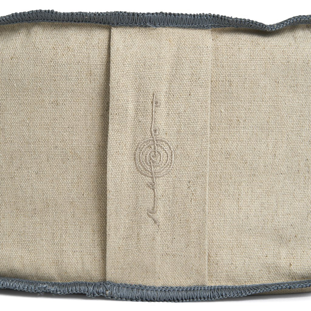Natural linen fabric with embroidered menorah symbol and charcoal gray whipstitch trim along edges