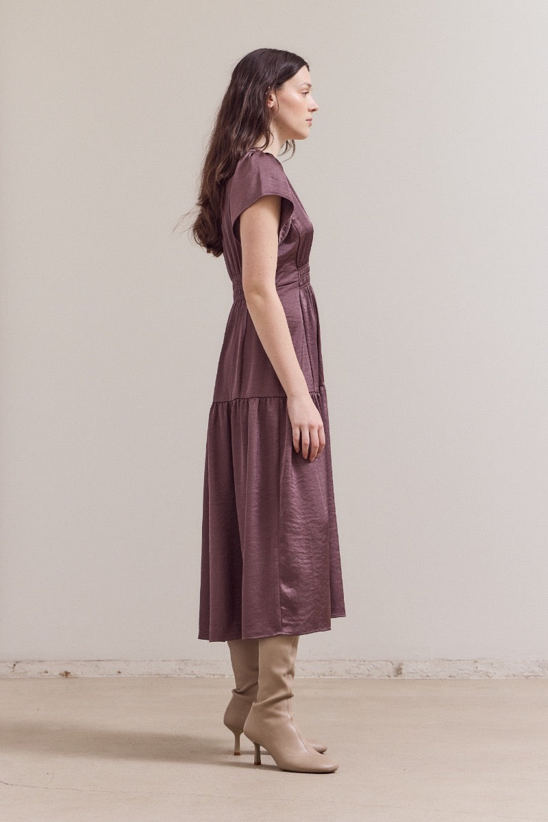 Mauve purple midi dress with cap sleeves, fitted waist, and tiered gathered skirt worn with beige knee-high boots