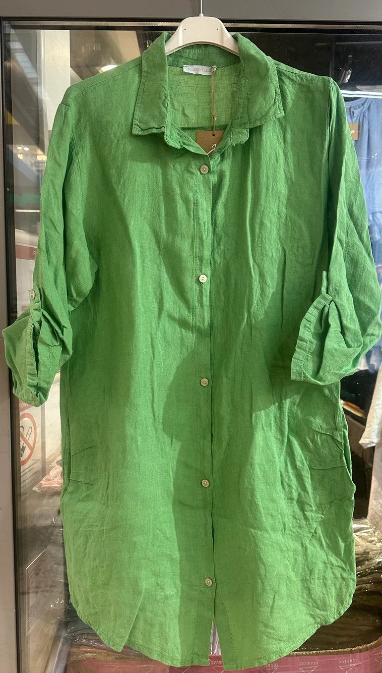 Bright grass green linen tunic with collar, white button front, and rolled three-quarter sleeves on white hanger