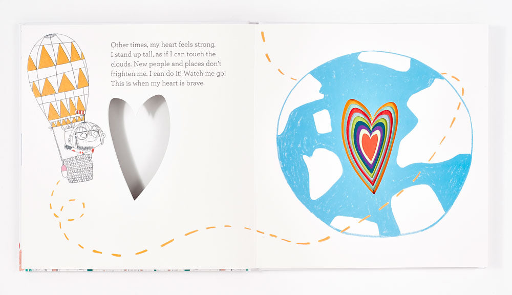 Children's book spread showing hot air balloon with character, silver heart cutout, and blue globe with rainbow heart design