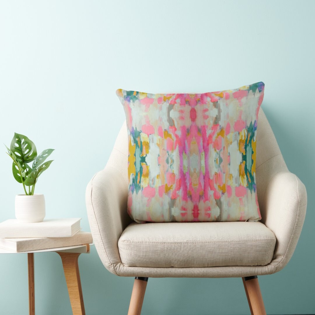 Abstract watercolor pillow with pink, teal, mustard and cream brushstroke pattern in vertical mirrored design