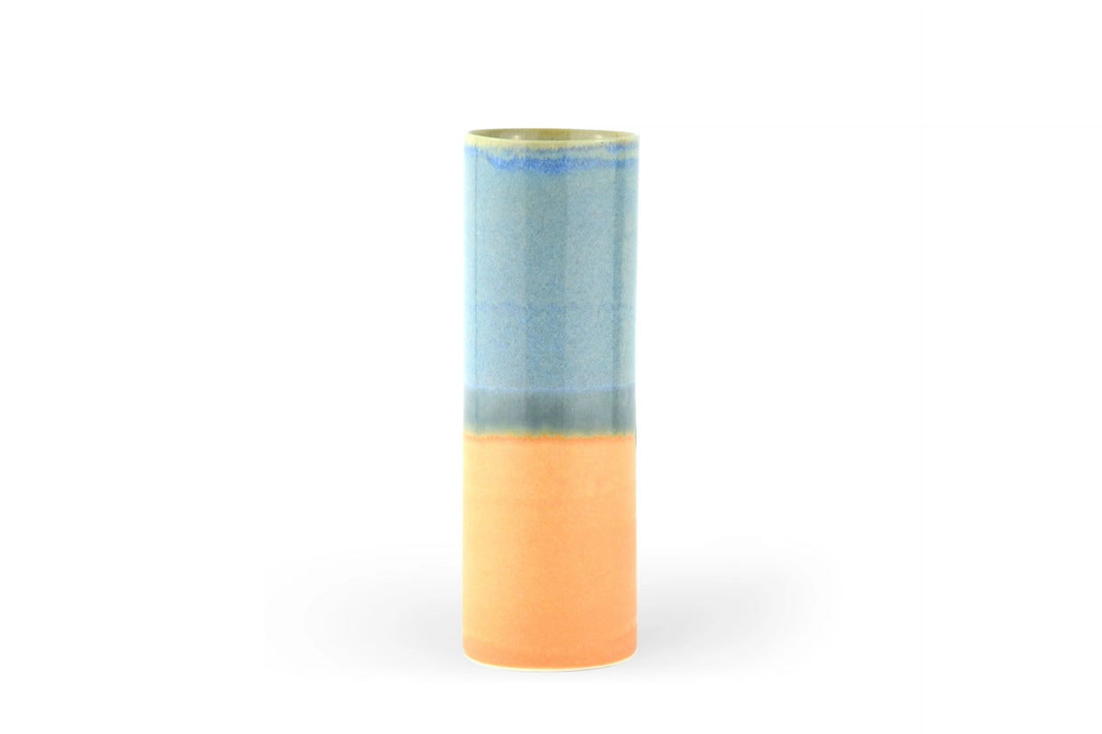 Cylindrical ceramic vase with sky blue glazed upper half and peachy-orange lower half with organic color transition