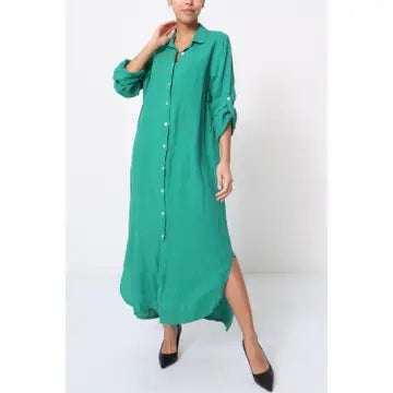Emerald green linen maxi shirt dress with button front, rolled sleeves, collar, and side slit worn with black heels