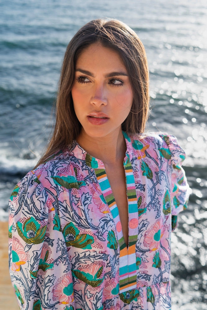 Cotton kimono robe in lavender with oversized pink and teal floral print and striped trim detail at ocean backdrop