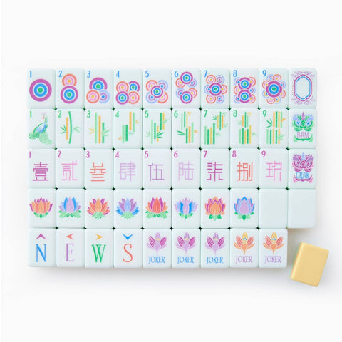 White mahjong tiles with pastel pink, blue, yellow designs featuring circles, bamboo, Chinese characters, lotus flowers, and peacock