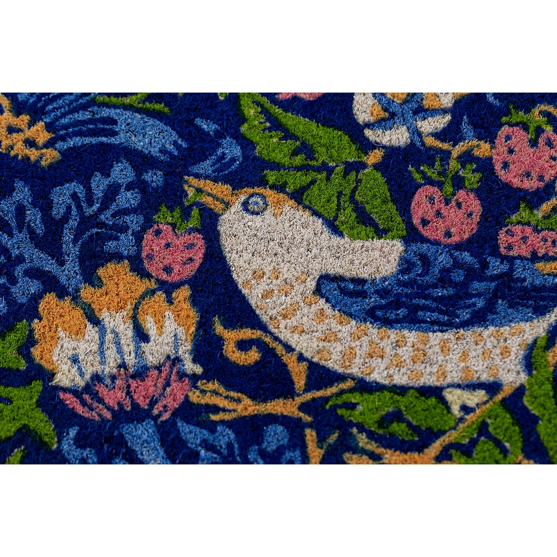 Embroidered textile with cream unicorn, pink flowers, green leaves, and gold decorative motifs on deep navy blue fabric