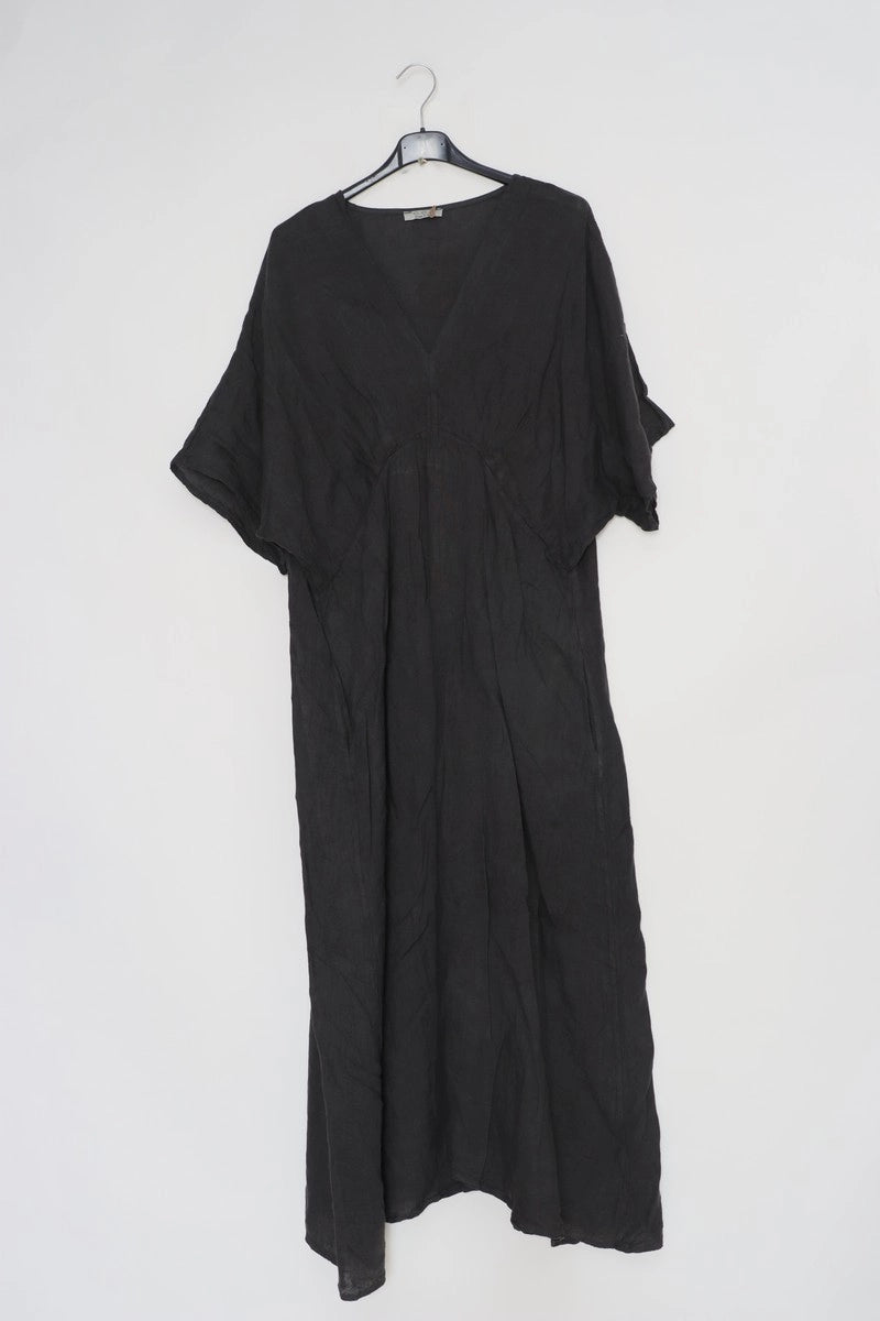 Black linen caftan dress with V-neck, dolman sleeves, gathered empire waist, and relaxed maxi length on hanger