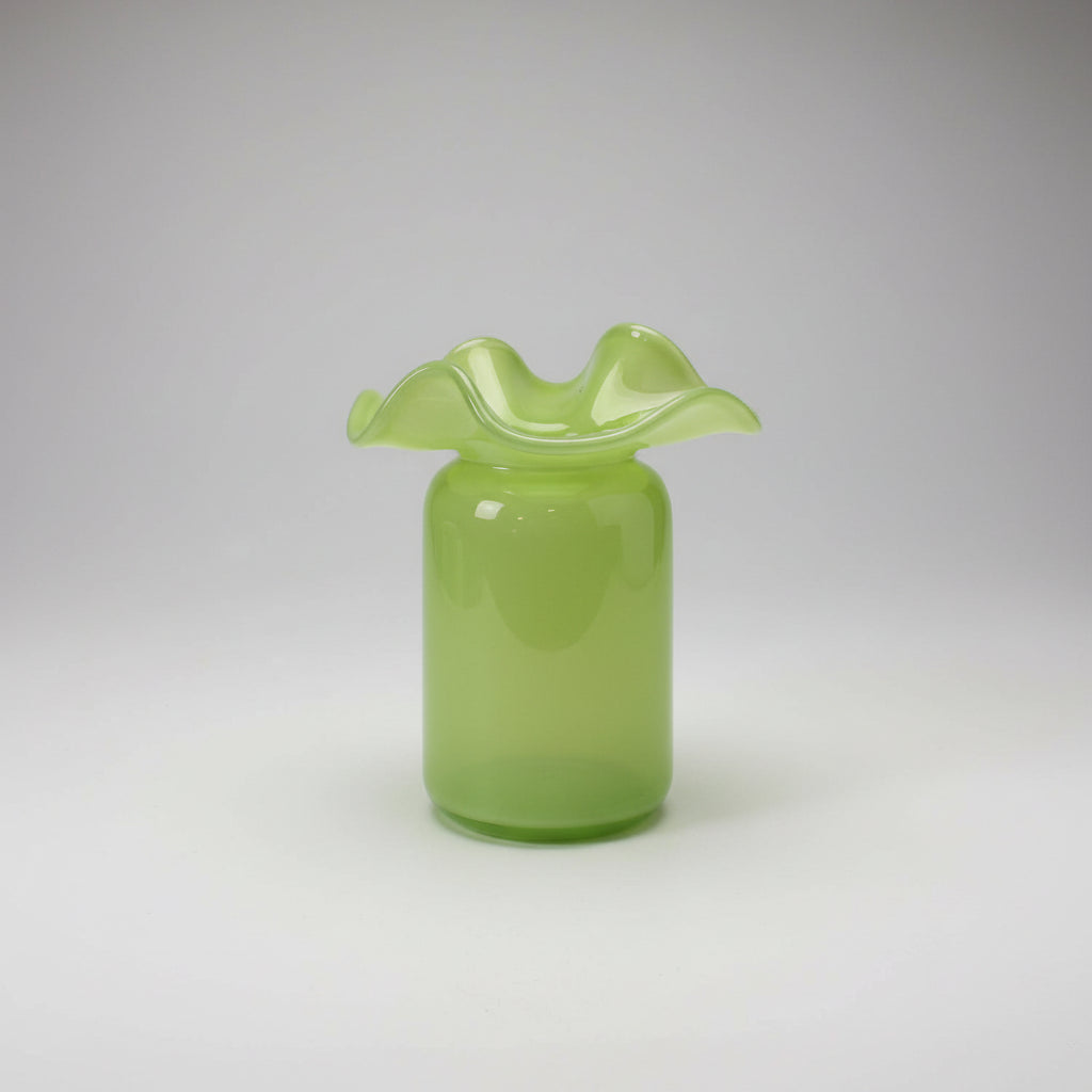 Chartreuse green glass vase with ruffled wavy rim, cylindrical body, and glossy finish with subtle speckled texture