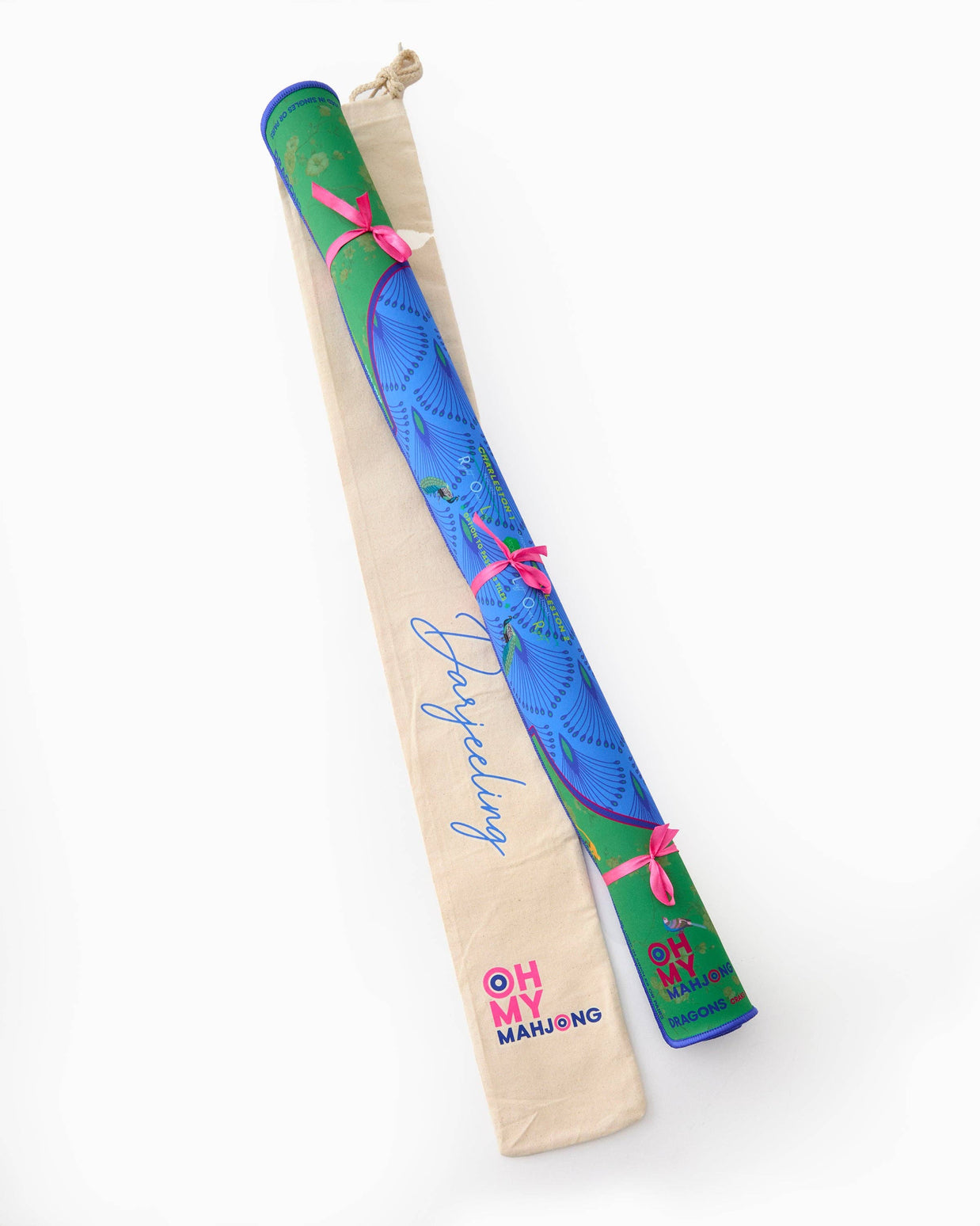 Decorative incense sticks in green and blue printed paper with vibrant peacock feather design tied with pink ribbon bows