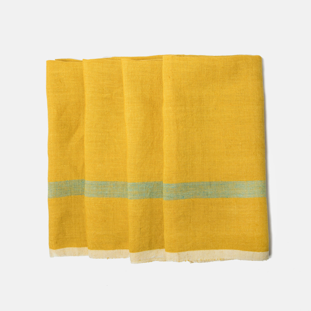 Folded linen towel in golden yellow with pale mint green stripe and cream border showing textured weave on white surface