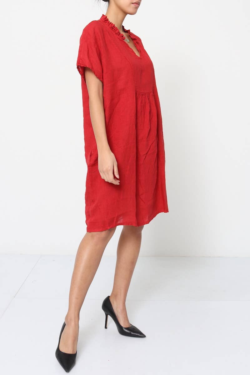 Coral red linen dress with ruffled neckline, gathered waist, short sleeves, and knee-length relaxed silhouette